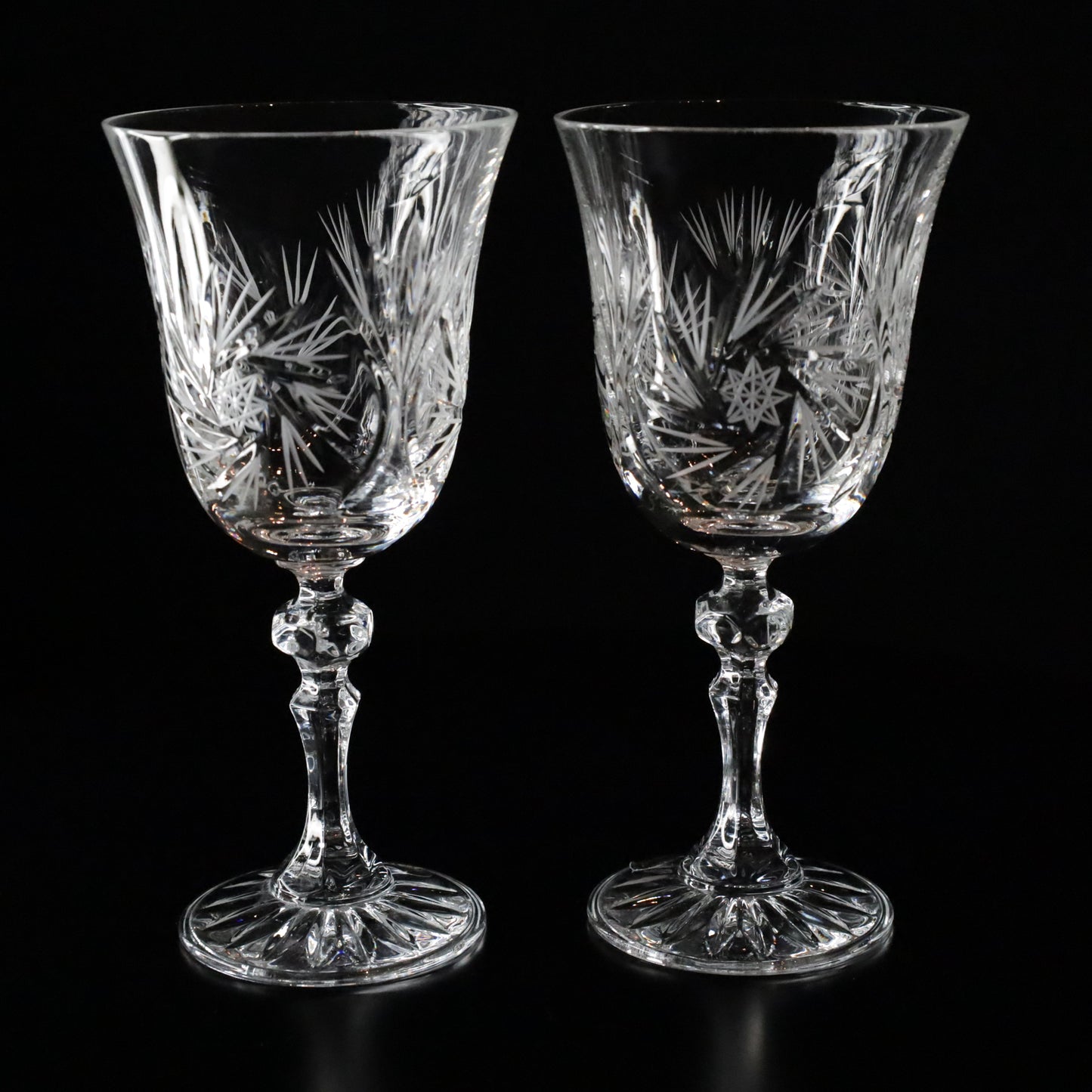 A collection of six Antoinette crystal white wine glasses, showcasing intricate detailing and refined craftsmanship
