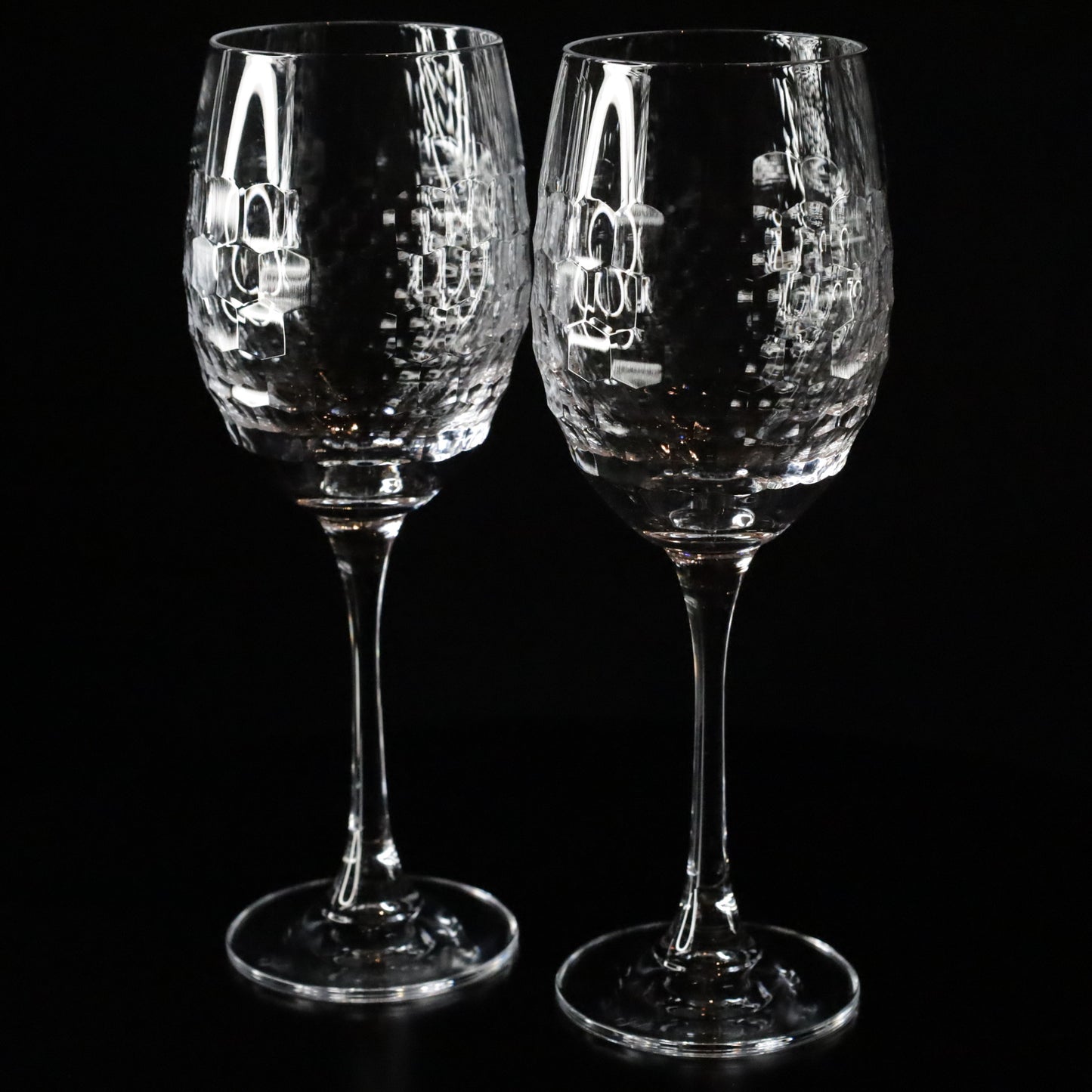 A pair of Lily red wine glasses crafted with a unique textured pattern, offering a luxurious and modern design for any occasion.