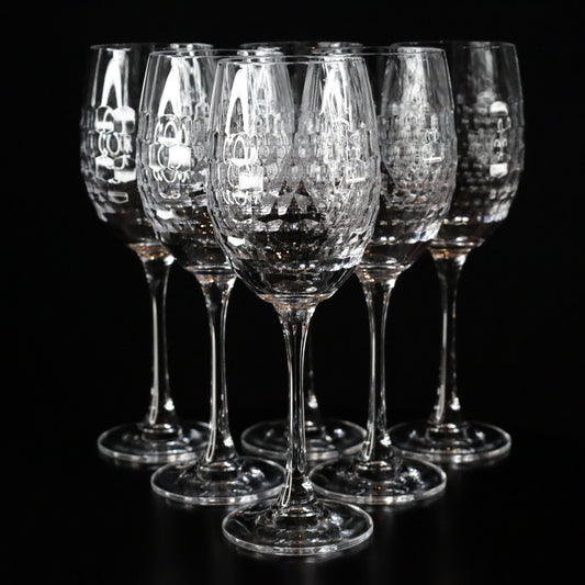 Elegant Lily red wine glasses featuring a textured crystal design and slender stems, displayed in a set of two against a sleek black background.