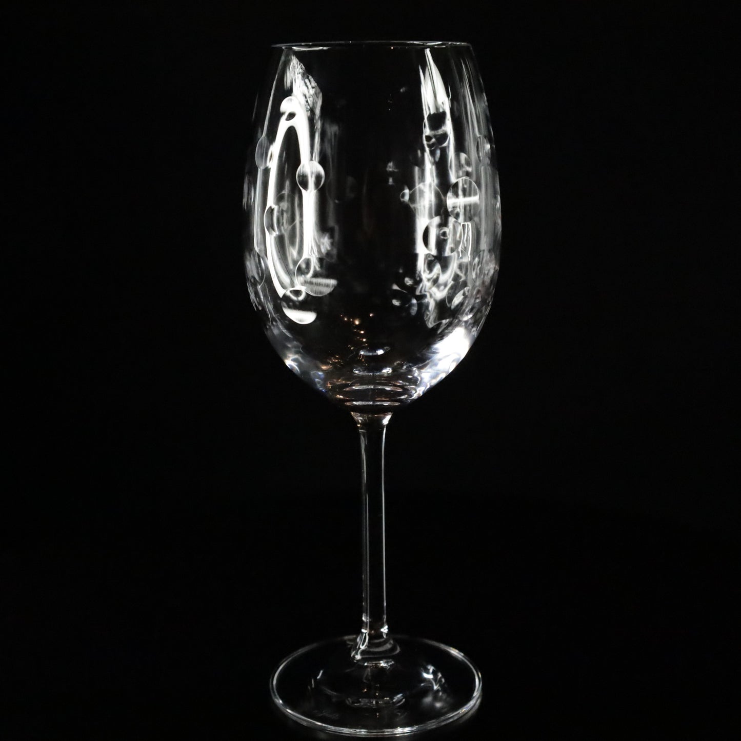 Sophisticated Nebula red wine glasses with intricate bubble-like etchings and a modern design, perfect for enhancing wine enjoyment.