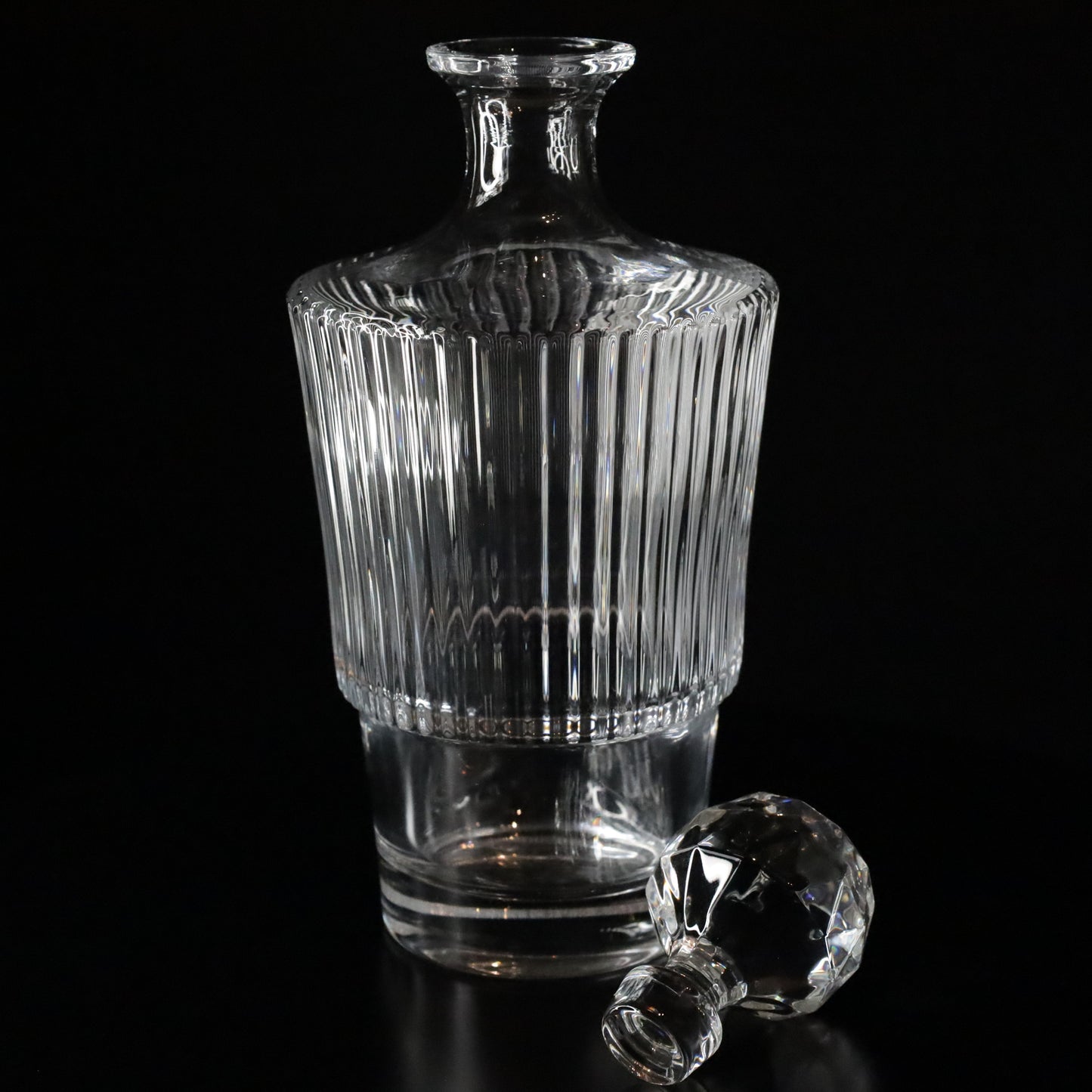 A Serenity crystal wine decanter showcasing intricate ribbed patterns and a refined silhouette, ideal for elegant dining occasions.