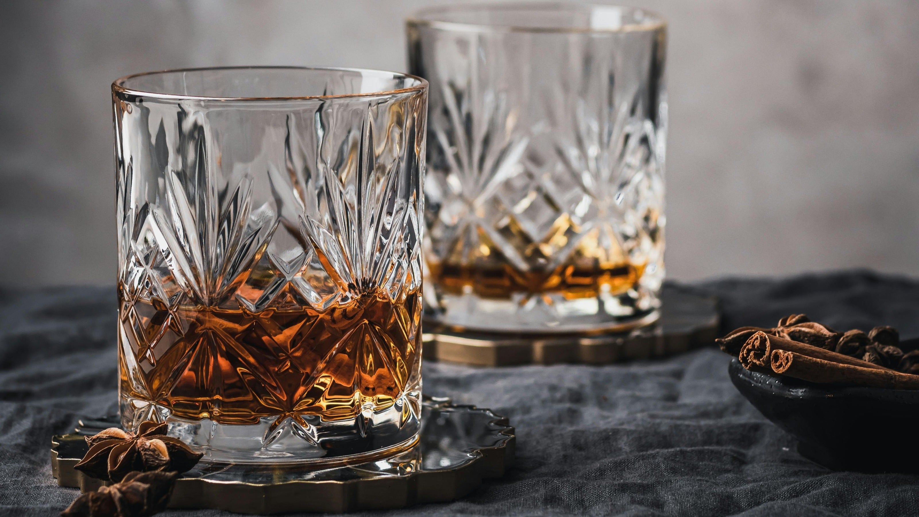 crystal whisky glasses on bright background