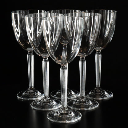 Elegant Aurora white wine glasses with a refined, minimalist design, displayed in a set of six on a sleek black surface.
