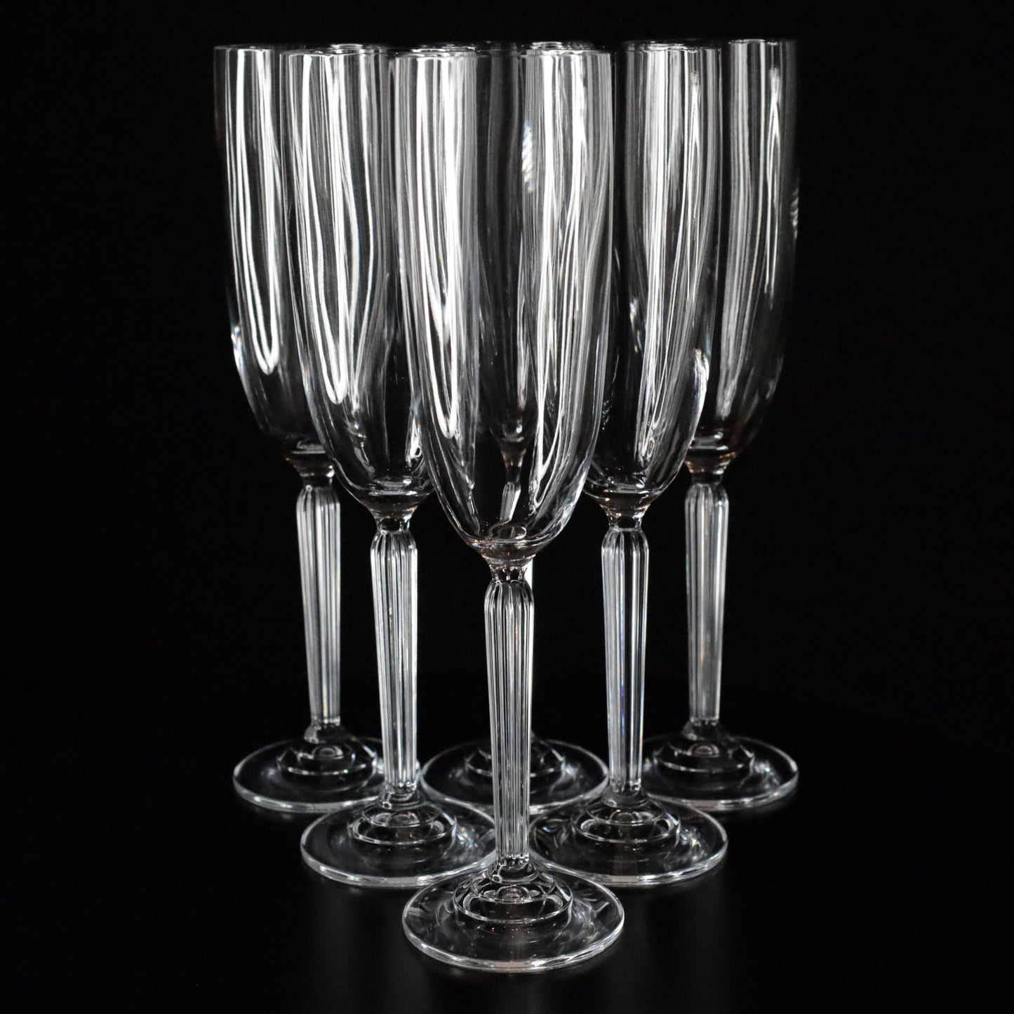 Set of 6 Aurora champagne flutes with a slender stem and clean lines, photographed against a dark, elegant backdrop.
