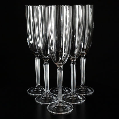 Set of 6 Aurora champagne flutes with a slender stem and clean lines, photographed against a dark, elegant backdrop.