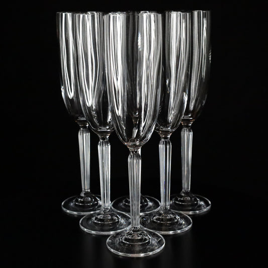 Set of 6 Aurora champagne flutes with a slender stem and clean lines, photographed against a dark, elegant backdrop.