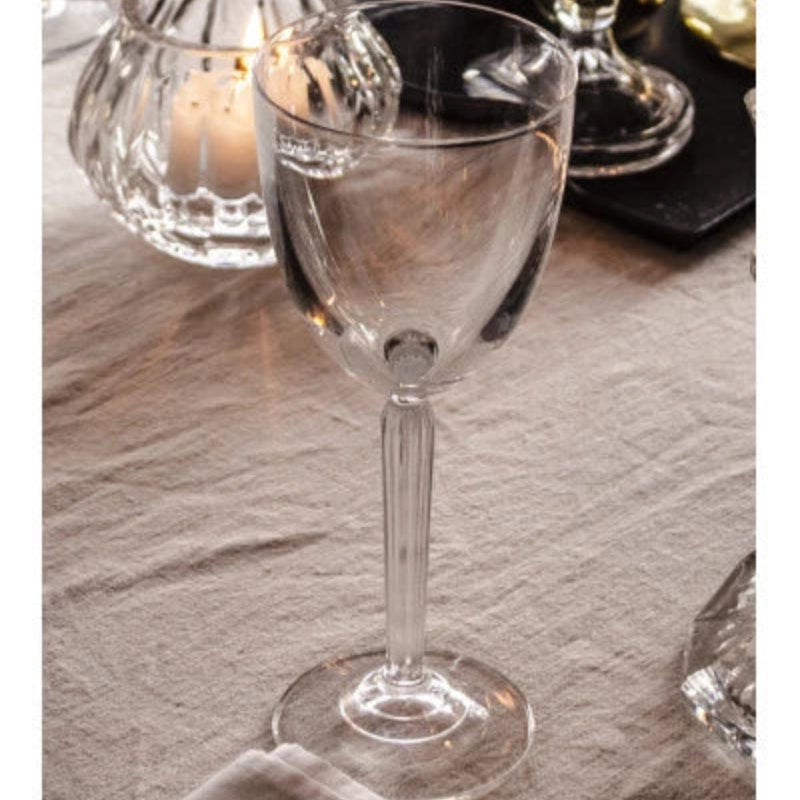 A beautifully crafted Aurora Wine Glass with a tapered bowl and elegant stem, perfect for red or white wine, displayed on a sophisticated dining table.