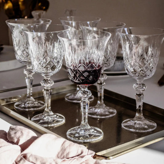 A set of Crown Wine Glasses made from premium crystal, featuring intricate etching and sculpted stems, perfect for red or white wines.