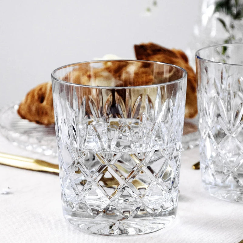 A premium Crown Whiskey Glass made of crystal with an intricate etched design, perfect for enhancing whiskey, bourbon, or scotch experiences.